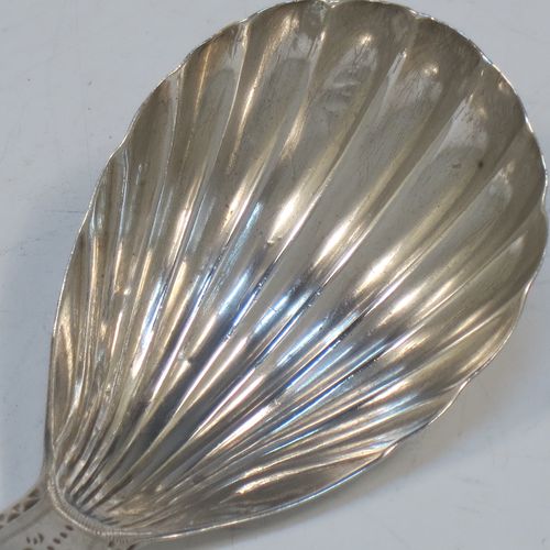 A very elegant Antique Georgian Sterling Silver tea caddy spoon, having an engraved curved handle, and a hand-chased shell style oval bowl. Made in London in 1788. The dimensions of this fine hand-made antique silver tea caddy spoon are length 7 cms (2.75 inches), width 3.5 cms (1.3 inches), and it weighs approx. 11g (0.4 troy ounces). Please note that this item is monogrammed.   