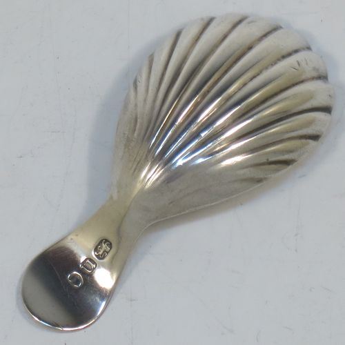 A very elegant Antique Georgian Sterling Silver tea caddy spoon, having an engraved curved handle, and a hand-chased shell style oval bowl. Made in London in 1788. The dimensions of this fine hand-made antique silver tea caddy spoon are length 7 cms (2.75 inches), width 3.5 cms (1.3 inches), and it weighs approx. 11g (0.4 troy ounces). Please note that this item is monogrammed.   