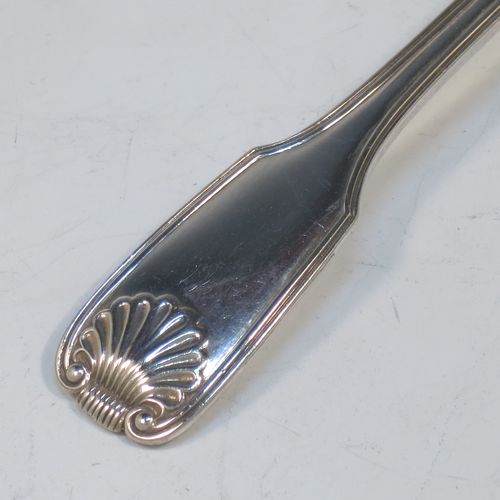 An Antique Georgian Sterling Silver tea caddy spoon, having a double-struck Fiddle, Thread, and Shell pattern handle, and a hand-engraved oval bowl with wriggle-work decoration. Made in ca. 1820 (marks rubbed). The dimensions of this fine hand-made antique silver tea caddy spoon are length 12 cms (4.75 inches), width across bowl 4.5 cms (1.75 inches), and it weighs approx. 27g (0.9 troy ounces).  