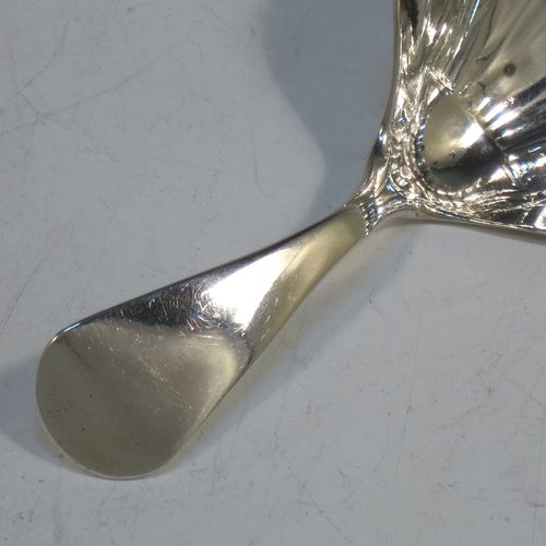 A very elegant Antique Georgian Sterling Silver tea caddy spoon, having a plain Old English pattern curved handle, and a hand-chased shell style shaped round bowl. Made by Thomas Hayter of London in 1807. The dimensions of this fine hand-made antique silver tea caddy spoon are length 8 cms (3.25 inches), width 4 cms (1.5 inches), and it weighs approx. 11g (0.4 troy ounces).   