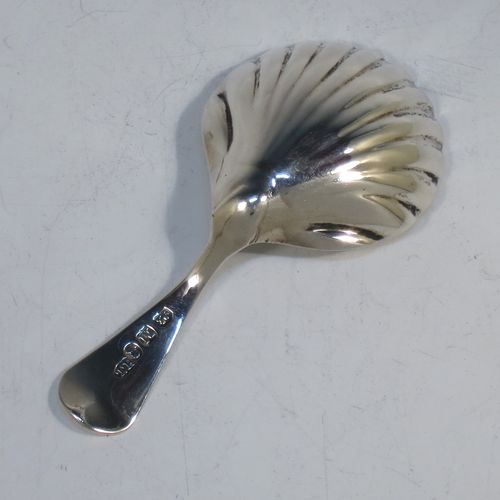 A very elegant Antique Georgian Sterling Silver tea caddy spoon, having a plain Old English pattern curved handle, and a hand-chased shell style shaped round bowl. Made by Thomas Hayter of London in 1807. The dimensions of this fine hand-made antique silver tea caddy spoon are length 8 cms (3.25 inches), width 4 cms (1.5 inches), and it weighs approx. 11g (0.4 troy ounces).   