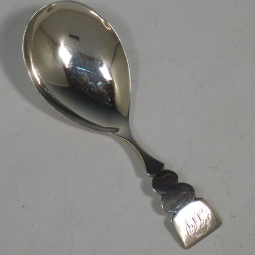 An Antique Georgian Sterling Silver tea caddy spoon, in a very plain style with a cut lobed handle, and an oval bowl. Made by Thomas James of London in 1808. The dimensions of this fine hand-made antique silver tea caddy spoon are length 9 cms (3.5 inches), width across bowl 3 cms (1.25 inches), and it weighs approx. 13g (0.4 troy ounces).    