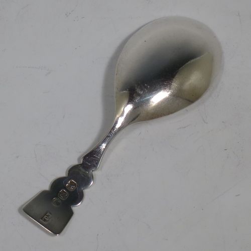 An Antique Georgian Sterling Silver tea caddy spoon, in a very plain style with a cut lobed handle, and an oval bowl. Made by Thomas James of London in 1808. The dimensions of this fine hand-made antique silver tea caddy spoon are length 9 cms (3.5 inches), width across bowl 3 cms (1.25 inches), and it weighs approx. 13g (0.4 troy ounces).    