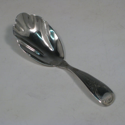 Antique Georgian sterling silver tea caddy spoon, having an engraved curved handle, and a fluted / scalloped bowl. Made by Reid and Sons of Newcastle in 1803. The dimensions of this fine hand-made silver tea caddy spoon are length 10 cms (4 inches), width 3.5 cms (1.3 inches), and it weighs approx. 14g (0.5 troy ounces).   