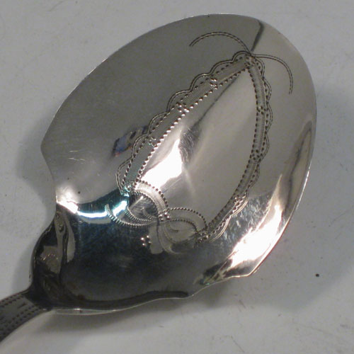 Antique Georgian sterling silver tea caddy spoon, having an engraved curved handle, and an engraved and bowl, with floral decoration. Made by Joseph Taylor of Birmingham in 1802. The dimensions of this fine hand-made silver tea caddy spoon are length 8 cms (3 inches), width 3.5 cms (1.3 inches), and it weighs approx. 6g (0.2 troy ounces).    