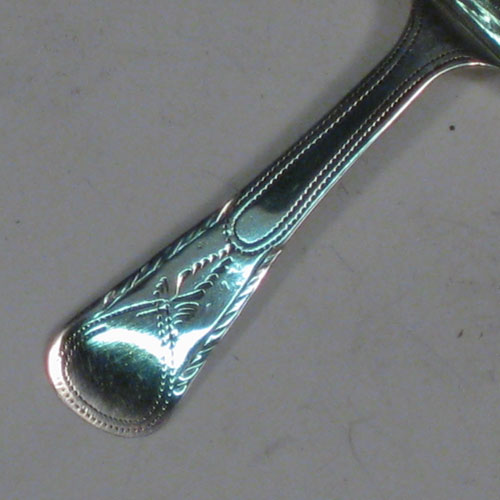 Antique Georgian sterling silver tea caddy spoon, having an engraved flat handle, and an engraved oval bowl, with floral decoration. Made by Joseph Taylor of Birmingham in 1800. The dimensions of this fine hand-made silver tea caddy spoon are length 7.5 cms (3 inches), width 4.5 cms (1.75 inches), and it weighs approx. 7g (0.2 troy ounces).    