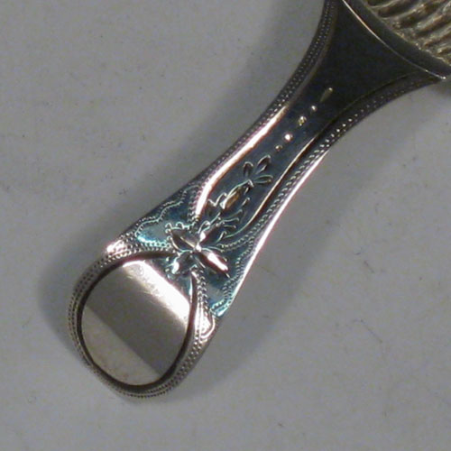 Antique Georgian sterling silver tea caddy spoon, having an engraved curved handle, and a hand-chased shell style bowl. Made by Peter, Anne, and William Bateman of London in 1800. The dimensions of this fine hand-made silver tea caddy spoon are length 8 cms (3 inches), width 4 cms (1.5 inches), and it weighs approx. 10g (0.3 troy ounces).