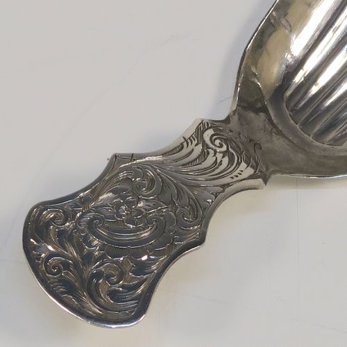 A very pretty Antique Victorian Sterling Silver tea caddy spoon, having a hand-engraved handle with floral and scroll decoration, and a hand-chased shell style bowl. This elegant antique silver tea caddy spoon was made by Thomas Danes of Birmingham in 1850. The dimensions of this fine hand-made antique silver tea caddy spoon are length 8 cms (3 inches), width 4 cms (1.5 inches), and it weighs approx. 7.5g (0.24 troy ounces).   