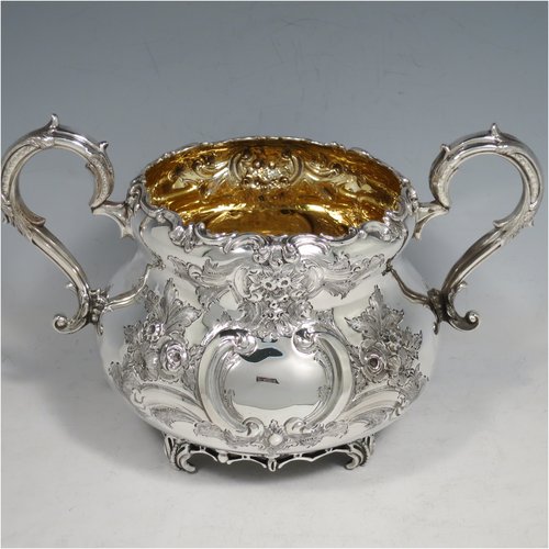 An Antique Victorian Sterling Silver four-piece tea and coffee set, having round baluster bodies  with hand-chased floral decoration, with silver insulated handles, cast eagle finials, eagle face spouts, the sugar bowl and cream jug with gold-gilt interiors, and all sitting on cast and hand-pierced feet. All made by Martin & Hall, with the teapot & cream jug from London in 1870, the coffee pot from Sheffield in 1890, and the sugar bowl from Sheffield in 1896. The dimensions of this fine hand-made silver tea and coffee service are length of teapot 27 cms (10.6 inches), height of coffee pot 26 cms (10.25 inches), and the total weight is approx. 2,253g (73 troy ounces).   