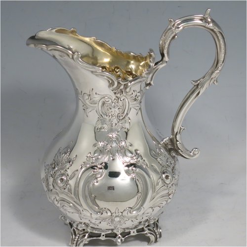 An Antique Victorian Sterling Silver four-piece tea and coffee set, having round baluster bodies  with hand-chased floral decoration, with silver insulated handles, cast eagle finials, eagle face spouts, the sugar bowl and cream jug with gold-gilt interiors, and all sitting on cast and hand-pierced feet. All made by Martin & Hall, with the teapot & cream jug from London in 1870, the coffee pot from Sheffield in 1890, and the sugar bowl from Sheffield in 1896. The dimensions of this fine hand-made silver tea and coffee service are length of teapot 27 cms (10.6 inches), height of coffee pot 26 cms (10.25 inches), and the total weight is approx. 2,253g (73 troy ounces).   