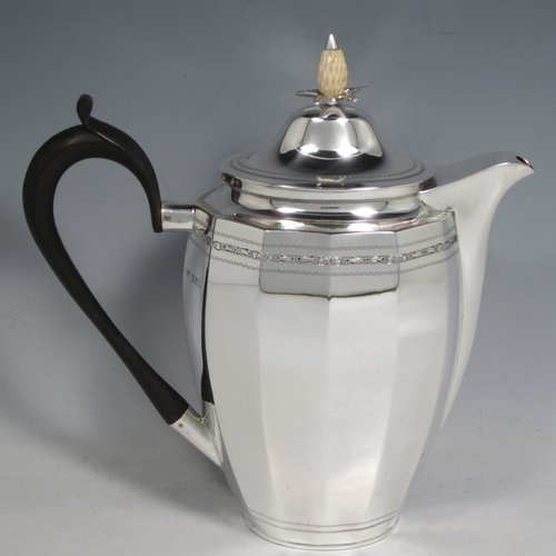 Sterling silver Georgian style five-piece tea and coffee service, consisting of teapot, coffee pot, hot water pot, sugar bowl and cream jug. Having oval panelled bodies with a band of floral decoration, with wooden handles and ivory pineapple shaped finials, and sitting on flat bases. Made by Roberts & Belk of Sheffield in 1919. The dimensions of this fine hand-made tea and coffee service are length of teapot 27 cms (10.5 inches), height of coffee pot 22 cms (8.75 inches), and the total weight is approx. 1,800g (58 troy ounces).