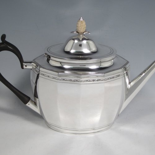 Sterling silver Georgian style five-piece tea and coffee service, consisting of teapot, coffee pot, hot water pot, sugar bowl and cream jug. Having oval panelled bodies with a band of floral decoration, with wooden handles and ivory pineapple shaped finials, and sitting on flat bases. Made by Roberts & Belk of Sheffield in 1919. The dimensions of this fine hand-made tea and coffee service are length of teapot 27 cms (10.5 inches), height of coffee pot 22 cms (8.75 inches), and the total weight is approx. 1,800g (58 troy ounces).