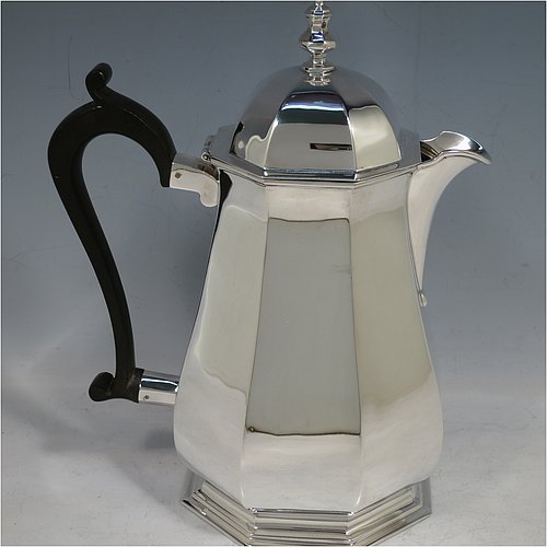 A handsome Sterling Silver Art Deco style four-piece tea and coffee service, having plain octagonal panelled and bellied bodies, with black wooden handles and cast finials, domed lids with hinges, and sitting on hexagonal pedestal feet. This elegant and stylish silver tea and coffee set was made by Roberts & Belk Sheffield in 1930. The dimensions of this fine hand-made tea and coffee service are length of teapot 24 cms (9.5 inches), height of coffee pot 23 cms (9 inches), and the total weight is approx. 1,925g (62 troy ounces).    