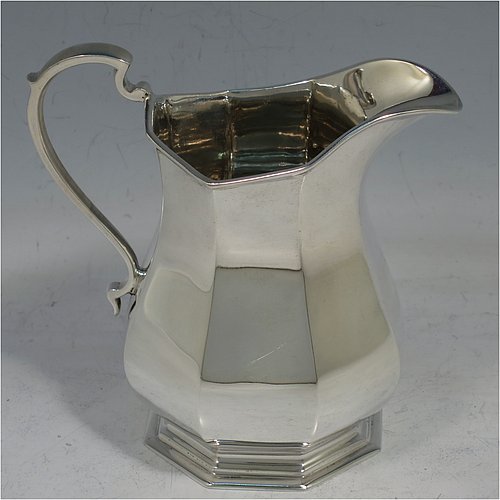 A handsome Sterling Silver Art Deco style four-piece tea and coffee service, having plain octagonal panelled and bellied bodies, with black wooden handles and cast finials, domed lids with hinges, and sitting on hexagonal pedestal feet. This elegant and stylish silver tea and coffee set was made by Roberts & Belk Sheffield in 1930. The dimensions of this fine hand-made tea and coffee service are length of teapot 24 cms (9.5 inches), height of coffee pot 23 cms (9 inches), and the total weight is approx. 1,925g (62 troy ounces).    