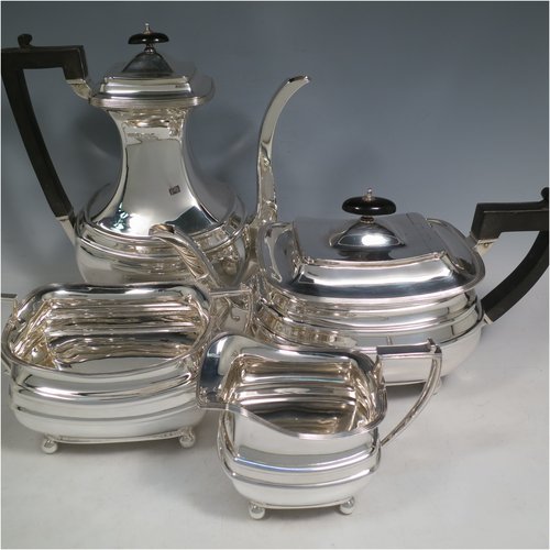 A Sterling Silver four-piece tea and coffee set, having plain rectangular baluster bodies with rounded corners and reeded borders, with wooden handles and finials, and all sitting on four ball feet. Made by James Dixon & Sons of Sheffield in 1927. The dimensions of this fine hand-made silver tea and coffee service are length of teapot 29 cms (11.5 inches), height of coffee pot pot 24 cms (9.5 inches), and the total weight is approx. 1,842g (59 troy ounces).   