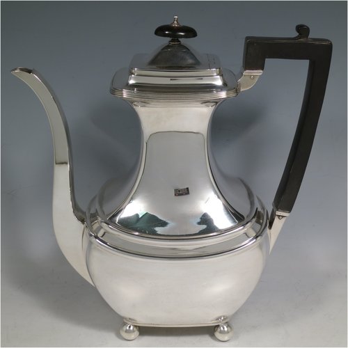 A Sterling Silver four-piece tea and coffee set, having plain rectangular baluster bodies with rounded corners and reeded borders, with wooden handles and finials, and all sitting on four ball feet. Made by James Dixon & Sons of Sheffield in 1927. The dimensions of this fine hand-made silver tea and coffee service are length of teapot 29 cms (11.5 inches), height of coffee pot pot 24 cms (9.5 inches), and the total weight is approx. 1,842g (59 troy ounces).   