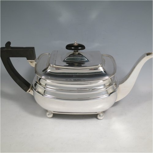 A Sterling Silver four-piece tea and coffee set, having plain rectangular baluster bodies with rounded corners and reeded borders, with wooden handles and finials, and all sitting on four ball feet. Made by James Dixon & Sons of Sheffield in 1927. The dimensions of this fine hand-made silver tea and coffee service are length of teapot 29 cms (11.5 inches), height of coffee pot pot 24 cms (9.5 inches), and the total weight is approx. 1,842g (59 troy ounces).   