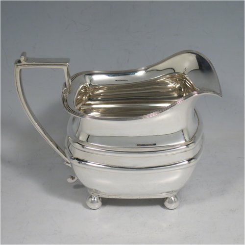 A Sterling Silver four-piece tea and coffee set, having plain rectangular baluster bodies with rounded corners and reeded borders, with wooden handles and finials, and all sitting on four ball feet. Made by James Dixon & Sons of Sheffield in 1927. The dimensions of this fine hand-made silver tea and coffee service are length of teapot 29 cms (11.5 inches), height of coffee pot pot 24 cms (9.5 inches), and the total weight is approx. 1,842g (59 troy ounces).   