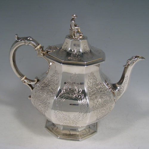 A beautiful Antique Victorian Sterling Silver four-piece tea and coffee service, consisting of a coffee pot, tea pot, sugar bowl, and cream jug, having octagonal panelled bodies with hand-engraved floral and scroll decoration, hinged lids with figural finials, and insulated silver handles. This fantastic antique silver tea and coffee service was made by William Theobald of London in 1845. The dimensions of this fine hand-made set are height of coffee pot 29 cms (11.5 inches), length of teapot 24 cms (9.5 inches), and with a total weight of approx. 2,341g (75.5 troy ounces).