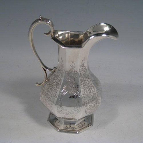 A beautiful Antique Victorian Sterling Silver four-piece tea and coffee service, consisting of a coffee pot, tea pot, sugar bowl, and cream jug, having octagonal panelled bodies with hand-engraved floral and scroll decoration, hinged lids with figural finials, and insulated silver handles. This fantastic antique silver tea and coffee service was made by William Theobald of London in 1845. The dimensions of this fine hand-made set are height of coffee pot 29 cms (11.5 inches), length of teapot 24 cms (9.5 inches), and with a total weight of approx. 2,341g (75.5 troy ounces).