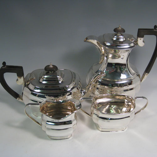 An elegant Sterling Silver four-piece tea and coffee set, having plain panelled baluster bodies, and wooden handles and finials, all sitting on flat bases. This handsome silver tea and coffee set was made by Harrison Fisher and Co., of Sheffield in 1947. The dimensions of this fine hand-made silver tea and coffee service are length of teapot 27 cms (10.5 inches), height of hot-water pot 23 cms (9 inches), and the total weight is approx. 52 troy ounces (1,612g).