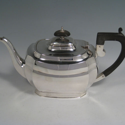 An elegant Sterling Silver four-piece tea and coffee set, having plain panelled baluster bodies, and wooden handles and finials, all sitting on flat bases. This handsome silver tea and coffee set was made by Harrison Fisher and Co., of Sheffield in 1947. The dimensions of this fine hand-made silver tea and coffee service are length of teapot 27 cms (10.5 inches), height of hot-water pot 23 cms (9 inches), and the total weight is approx. 52 troy ounces (1,612g).