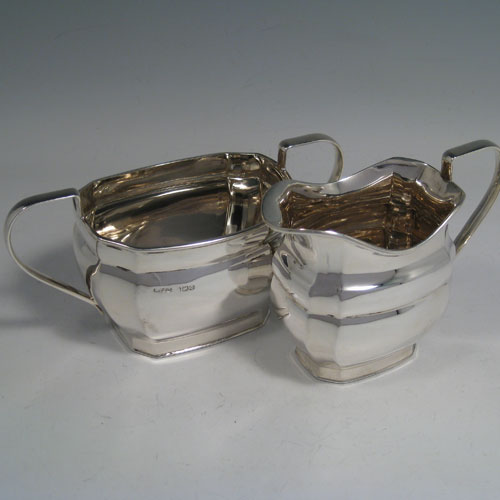 An elegant Sterling Silver four-piece tea and coffee set, having plain panelled baluster bodies, and wooden handles and finials, all sitting on flat bases. This handsome silver tea and coffee set was made by Harrison Fisher and Co., of Sheffield in 1947. The dimensions of this fine hand-made silver tea and coffee service are length of teapot 27 cms (10.5 inches), height of hot-water pot 23 cms (9 inches), and the total weight is approx. 52 troy ounces (1,612g).