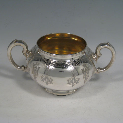 A very pretty Antique Victorian Sterling Silver four-piece tea and coffee service, consisting of a coffee pot, tea pot, sugar bowl, and cream jug, having round bodies with hand-engraved styalised decoration, hinged lids with finials, and insulated silver handles. This beautiful antique silver tea and coffee service was made by Henry Holland of London in 1865. The dimensions of this fine hand-made silver service are height of coffee pot 25.5 cms (10 inches), length of teapot 26.5 cms (10.5 inches), and with a total weight approx. 1,998g (64.5 troy ounces).