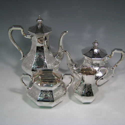 A very pretty Antique Victorian Sterling Silver four-piece tea and coffee service, consisting of a coffee pot, tea pot, sugar bowl, and cream jug, having octagonal panelled bodies with hand-engraved floral and scroll decoration, hinged lids with finials, and insulated silver handles. This beautiful antique silver tea and coffee set was made by William Kerr Reid of London in 1850. The dimensions of this fine hand-made silver service are height of coffee pot 25 cms (10 inches), length of teapot 23.5 cms (9.25 inches), and with a total weight approx. 1,740g (56 troy ounces).