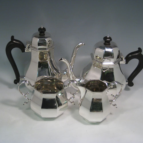    Sterling silver tea and coffee service, consisting of a coffee pot, teapot, sugar bow, and cream jug, having panelled bodies, wooden handles and finials, and hinged domed lids. Made by Garrards of London in 1957. Height of coffee pot 22 cms (8.75 inches), length of teapot 26 cms (10.75 inches). Total weight approx. 2,350g (75.8 troy ounces).