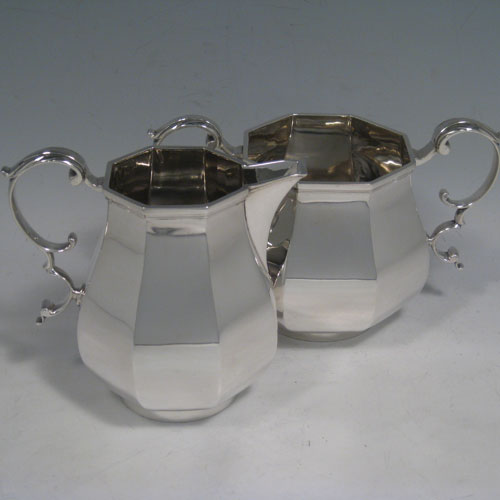    Sterling silver tea and coffee service, consisting of a coffee pot, teapot, sugar bow, and cream jug, having panelled bodies, wooden handles and finials, and hinged domed lids. Made by Garrards of London in 1957. Height of coffee pot 22 cms (8.75 inches), length of teapot 26 cms (10.75 inches). Total weight approx. 2,350g (75.8 troy ounces).