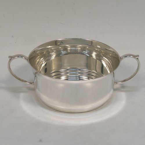 A very handsome and stylish Sterling Silver Art Deco style four-piece tea and coffee service, having very plain round bodies, with brown stained wooden handles and finials, and all sitting on flat stepped bases. This very elegant silver tea and coffee service was made by Alvic Products Ltd., of Birmingham in 1947. The dimensions of this fine hand-made Art Deco style tea and coffee set are length of teapot 23 cms (9 inches), height of coffee pot 15 cms (6 inches), and the total weight is approx. 1,127g (36 troy ounces).  