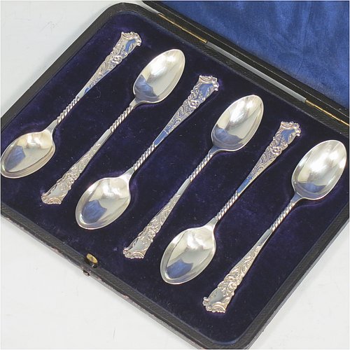 An Antique Edwardian Sterling Silver set of six tea or coffee spoons, having plain oval bowls, and handles with twisted stems and hand-chased ends with floral decoration, all in their original dark blue satin and velvet-lined presentation box. Made in Sheffield in 1904. The dimensions of this fine hand-made set of teaspoons or coffee spoons are length of each spoon 11 cms (4.25 inches), and the total weight is approx. 90g (3 troy ounces).   