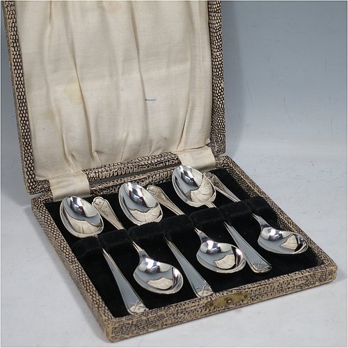 A Sterling Silver set of six tea or coffee spoons, having plain oval bowls, handles with reeded borders, and having crossed golf clubs and ball motifs on the ends, all in their original cream satin and black velvet-lined presentation box. Made by Walker & Hall of Sheffield in 1933. The dimensions of this fine hand-made set of teaspoons or coffee spoons are length of each spoon 11 cms (4.3 inches), and the total weight is approx. 78g (2.5 troy ounces).    