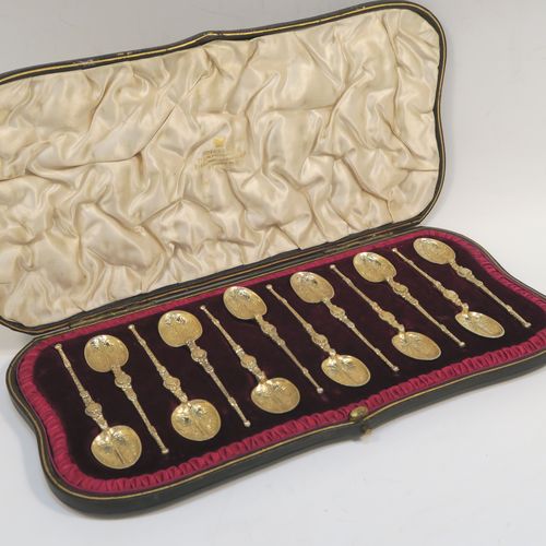 A beautiful set of twelve Antique Victorian Sterling Silver and gold-gilt coffee spoons, in the Coronation Anointing pattern with hand-engraved floral decoration to the bowls, and cast ornate handles, all in their original cream satin and maroon velvet-lined presentation box. These pretty antique silver and gold-gilt coffee spoons were made by Wakely and Wheeler of London in 1901. The dimensions of this fine hand-made antique silver set of coffee spoons are length of each spoon 10.5 cms (4.25 inches), and the total weight is approx. 135g (4.4 troy ounce).  