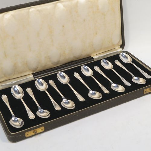 An elegant Antique Sterling Silver set of twelve teaspoons or coffee spoons, having plain oval bowls, and handles with a single-struck floral pattern, all in a cream satin and black velvet-lined presentation box. These pretty silver spoons were made by Allen and Darwin of Sheffield in 1912. The dimensions of this fine hand-made set of coffee spoons or teaspoons are length of each spoon 10 cms (4 inches), and the total weight is approx. 94g (3 troy ounce).   