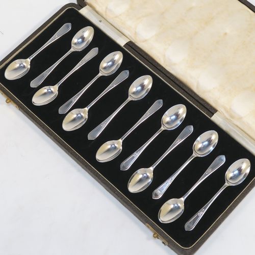 An elegant Antique Sterling Silver set of twelve teaspoons or coffee spoons, having plain oval bowls, and handles with a single-struck floral pattern, all in a cream satin and black velvet-lined presentation box. These pretty silver spoons were made by Allen and Darwin of Sheffield in 1912. The dimensions of this fine hand-made set of coffee spoons or teaspoons are length of each spoon 10 cms (4 inches), and the total weight is approx. 94g (3 troy ounce).   