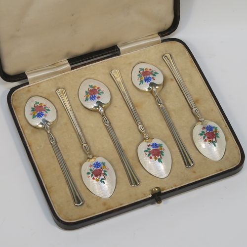 An extremely pretty Antique Sterling Silver and enamelled set of six tea or coffee spoons, having hand-painted and enamelled spoon backs in a floral design, all in their original cream satin and velvet-line presentation box. These beautiful antique silver and enamelled spoons were made by Turner and Simpson of Birmingham in 1915. The dimensions of this fine hand-made set of silver and enamelled teaspoons or coffee spoons are length of each spoon 10 cms (4 inches), and the total weight is approx. 66g (2.1 troy ounces). Please note that the enamel is in perfect order which is rare to find in spoons of this age.  