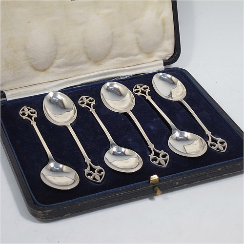 A pretty Sterling Silver set of six tea or coffee spoons, having plain oval bowls and hand-pierced Fleur-de-Lis style handles, all fitted into their original cream satin and dark blue velvet-lined presentation box. Made by Mappin and Webb of Birmingham in 1925. The dimensions of this fine hand-made set of teaspoons or coffee spoons are length of each spoon 11 cms (4.3 inches), with a total weight of approx. 55g (1.8 troy ounces).    