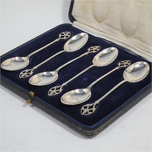 A pretty Sterling Silver set of six tea or coffee spoons, having plain oval bowls and hand-pierced Fleur-de-Lis style handles, all fitted into their original cream satin and dark blue velvet-lined presentation box. Made by Mappin and Webb of Birmingham in 1925. The dimensions of this fine hand-made set of teaspoons or coffee spoons are length of each spoon 11 cms (4.3 inches), with a total weight of approx. 55g (1.8 troy ounces).    