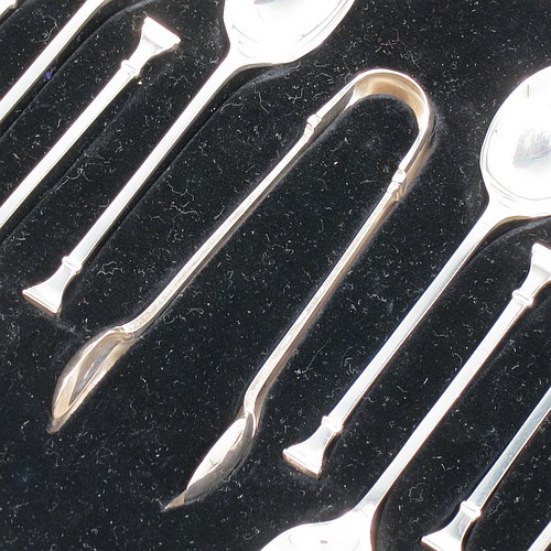 An Art Deco Sterling Silver set of 12 teaspoons or coffee spoons and sugar nips, having plain oval bowls, and handles in the Nail-End pattern, all in original cream satin and black velvet-lined presentation box. Made by the Cooper Brothers and Sons of Sheffield in 1923. The dimensions of this fine hand-made set of coffee spoons or teaspoons are length of each spoon 10 cms (4 inches), and the total weight is approx. 148g (4.8 troy ounce).    