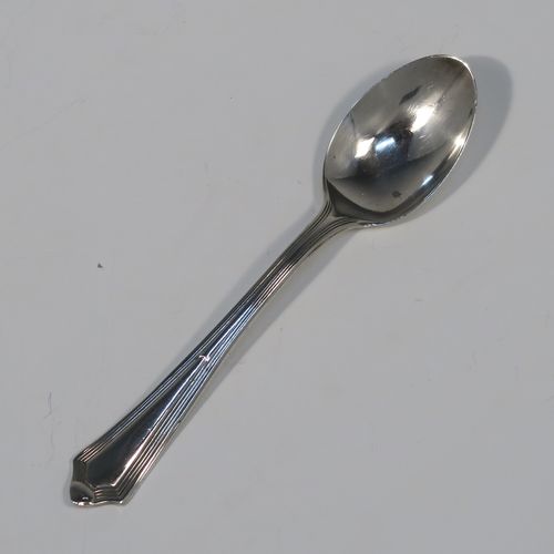 An elegant Art Deco style Sterling Silver set of twelve teaspoons or coffee spoons, having plain oval bowls, and handles with a single-struck reeded Pembury style pattern, all in their original cream satin and black velvet-lined presentation box. These pretty silver spoons were made by the Barker Brothers of Sheffield in 1936. The dimensions of this fine hand-made Art Deco set of sterling silver coffee spoons or teaspoons are length of each spoon 11 cms (4.3 inches), and the total weight is approx. 132g (4.3 troy ounce).   