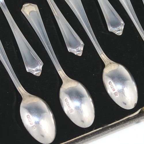 An elegant Art Deco style Sterling Silver set of twelve teaspoons or coffee spoons, having plain oval bowls, and handles with a single-struck reeded Pembury style pattern, all in their original cream satin and black velvet-lined presentation box. These pretty silver spoons were made by the Barker Brothers of Sheffield in 1936. The dimensions of this fine hand-made Art Deco set of sterling silver coffee spoons or teaspoons are length of each spoon 11 cms (4.3 inches), and the total weight is approx. 132g (4.3 troy ounce).   