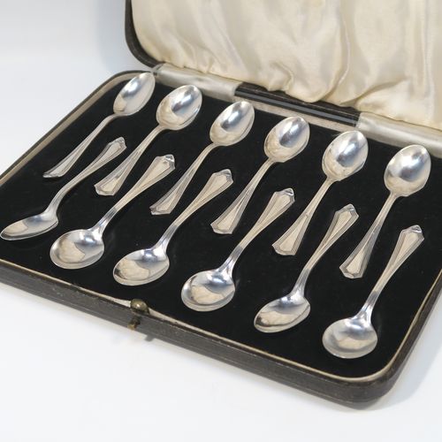 An elegant Art Deco style Sterling Silver set of twelve teaspoons or coffee spoons, having plain oval bowls, and handles with a single-struck reeded Pembury style pattern, all in their original cream satin and black velvet-lined presentation box. These pretty silver spoons were made by the Barker Brothers of Sheffield in 1936. The dimensions of this fine hand-made Art Deco set of sterling silver coffee spoons or teaspoons are length of each spoon 11 cms (4.3 inches), and the total weight is approx. 132g (4.3 troy ounce).   