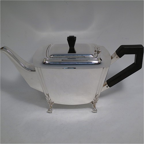 A very handsome and heavy Sterling Silver Art Deco three-piece tea set, consisting of a teapot, sugar bowl, and cream jug, in a plain rectangular panelled style with fluted corners, hand-cut stepped handles and matching finial, the teapot with a hinged lid, and all sitting on four cast scroll feet. Made by Joseph Gloster Ltd., of Birmingham in 1936. The dimensions of this fine hand-made Art Deco silver tea set are height of teapot 15 cms (6 inches), length 29 cms (11.3 inches), and it weighs a total of approx. 1,200g (39 troy ounces).