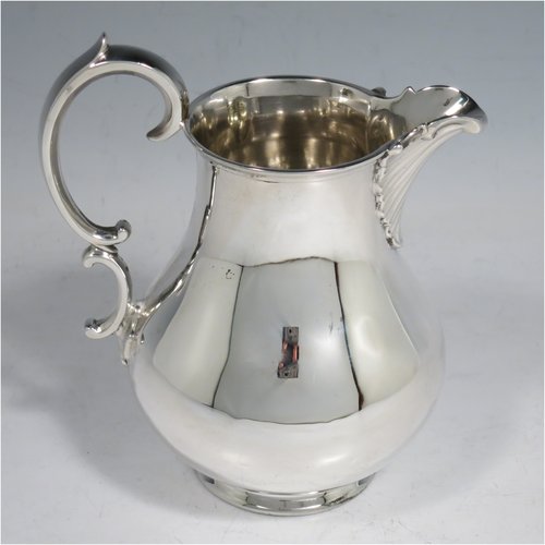 An Antique Victorian Sterling Silver three-piece  tea set, consisting of a teapot, sugar bowl and cream jug. The bodies in a plain round style with scroll handles, the teapot with silver handle and finial, and all sitting on collet feet. Made by the Barnard Brothers of London in 1847. The dimensions of this fine hand-made antique silver tea service are length of teapot 26 cms (10.25 inches), height 13.5 cms (5.25 inches), and it weighs a total of approx. 1,101g (35.5 troy ounces).   