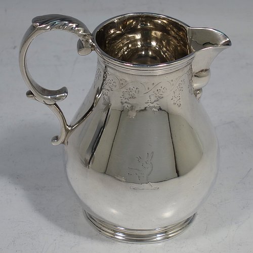 An Antique Victorian Sterling Silver three-piece tea set, consisting of teapot, sugar bowl, and cream jug, in a round bullet style with top bands of hand-engraved floral decoration, the teapot with a flat hinged lid, a panelled straight spout, and a wooden finial and scroll handle, the cream jug with a scroll handle and sparrow-beak spout, and all sitting on collet feet. Made by Joseph & Edwards Bradbury of London in 1876. The dimensions of this fine hand-made antique silver tea set are height of teapot 12 cms (4.75 inches), length 20 cms (8 inches), and it weighs a total of approx. 550g (17.7 troy ounces). Please note that all three pieces are part-crested.  