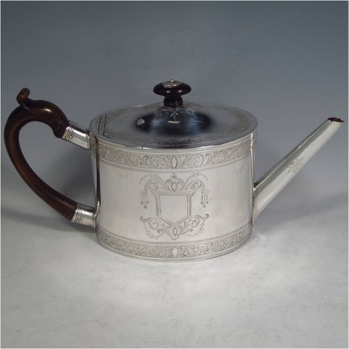 An Antique Georgian Sterling silver three-piece Neoclassical style tea set, having a teapot, sugar bowl and cream jug. The bodies all hand-engraved with bands of floral decoration and central cartouches, the sugar and creamer with applied reeded borders and pedestal feet, the teapot with wooden handle and finial, a flat base, and an invisibly hinged lid. Made by Samuel Meriton II of London in 1790/91. The dimensions of this fine hand-made silver tea service are length of teapot 27 cms (10.5 inches), height 14 cms (5.5 inches), and it weighs a total of approx. 830g (26.8 troy ounces). Please note that the teapot handle has had a small old repair close to the pins, but it does not affect the teapots usability, or deter from its prettiness.