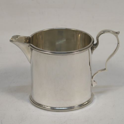 A very pretty Sterling Silver three-piece bachelor sized tea set, consisting of a teapot, sugar bowl, and cream jug, in a plain oval style with straight sides and applied bead-edged borders, the teapot with a brown wooden handle, finial, and a hinged domed lid with a flat invisible hinge, the sugar and creamer with scroll handles, and all sitting on flat bases. This beautiful silver bachelor size three-piece tea set was made by Roberts and Belk of Sheffield in 1940. The dimensions of this fine hand-made silver tea set are height of teapot 11.5 cms (4.5 inches), length 21.5 cms (8.5 inches), and it weighs a total of approx. 450g (14.5 troy ounces).  