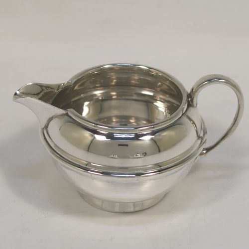 A very handsome Antique Sterling Silver Bachelor three-piece tea set, having plain round bellied shaped bodies, with central applied bands and loop handles, the teapot with a wooden handle and finial, and all sitting on round collet feet. This elegant antique silver bachelor tea set was all made by S. W. Smith and Co., of Birmingham in 1922. The dimensions of this fine hand-made antique silver bachelor tea set are length of teapot 20.5 cms (8 inches), height 10 cms (4 inches), and the total weight is approx. 468g (15 troy ounces).  